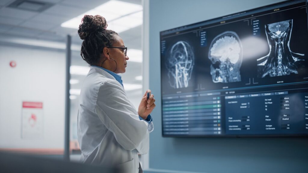 A CT scan of a human brain. Human experts solve problems with Google Artificial intelligence (AI), machine learning, & generative AI. Real-world applications of modern AI include using artificial intelligence to provide personalized care.