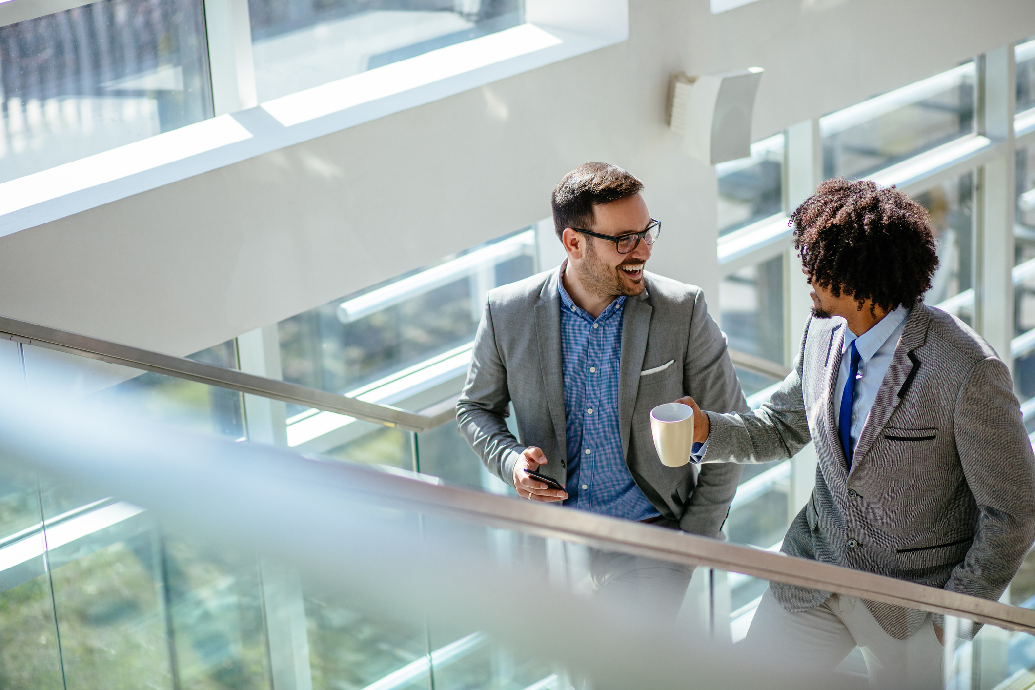 Two business colleagues talking while ascending stairs