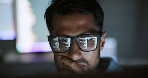 A close-up of a man wearing glasses, with code reflected in the lenses, representing a deep dive into technical AI concepts. This image speaks to the technical expertise and in-depth content provided by SADA's AI experts.
